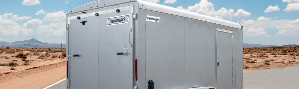 An enclosed Haulmark® trailer that's parked on a road in the desert